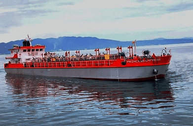 Large red and white tanker ship named ‘PRINCESS EMPRESS’ floating on calm blue waters with distant mountains under a light blue sky, symbolizing maritime transportation and global trade.